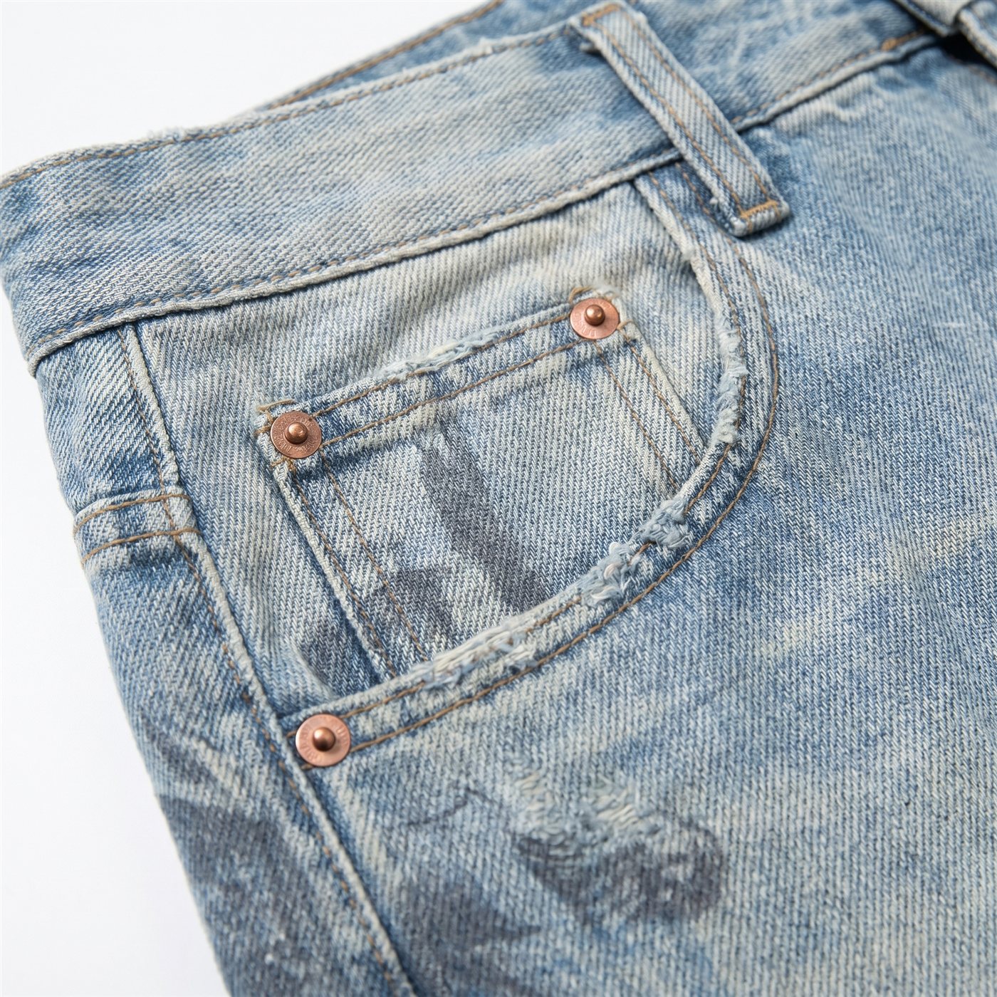 Macro close-up showing denim fabric, stitching and weave detail